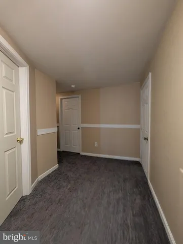 an empty room with windows and fireplace