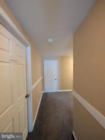 a view of an empty room and a window