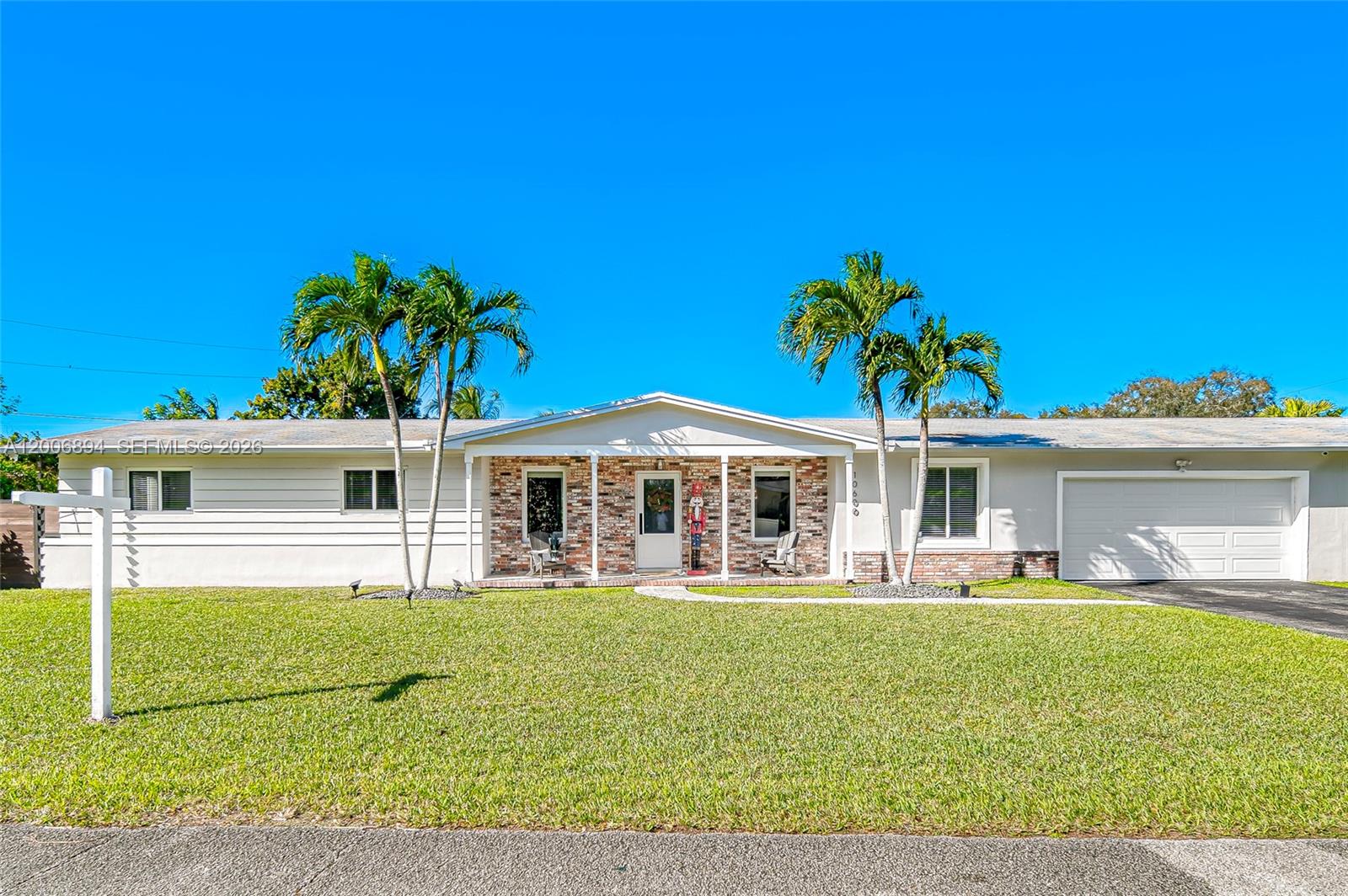 10600 Southwest 80th Court Miami, FL 33156 - Photo 1 of 51 a front view of a house with garden