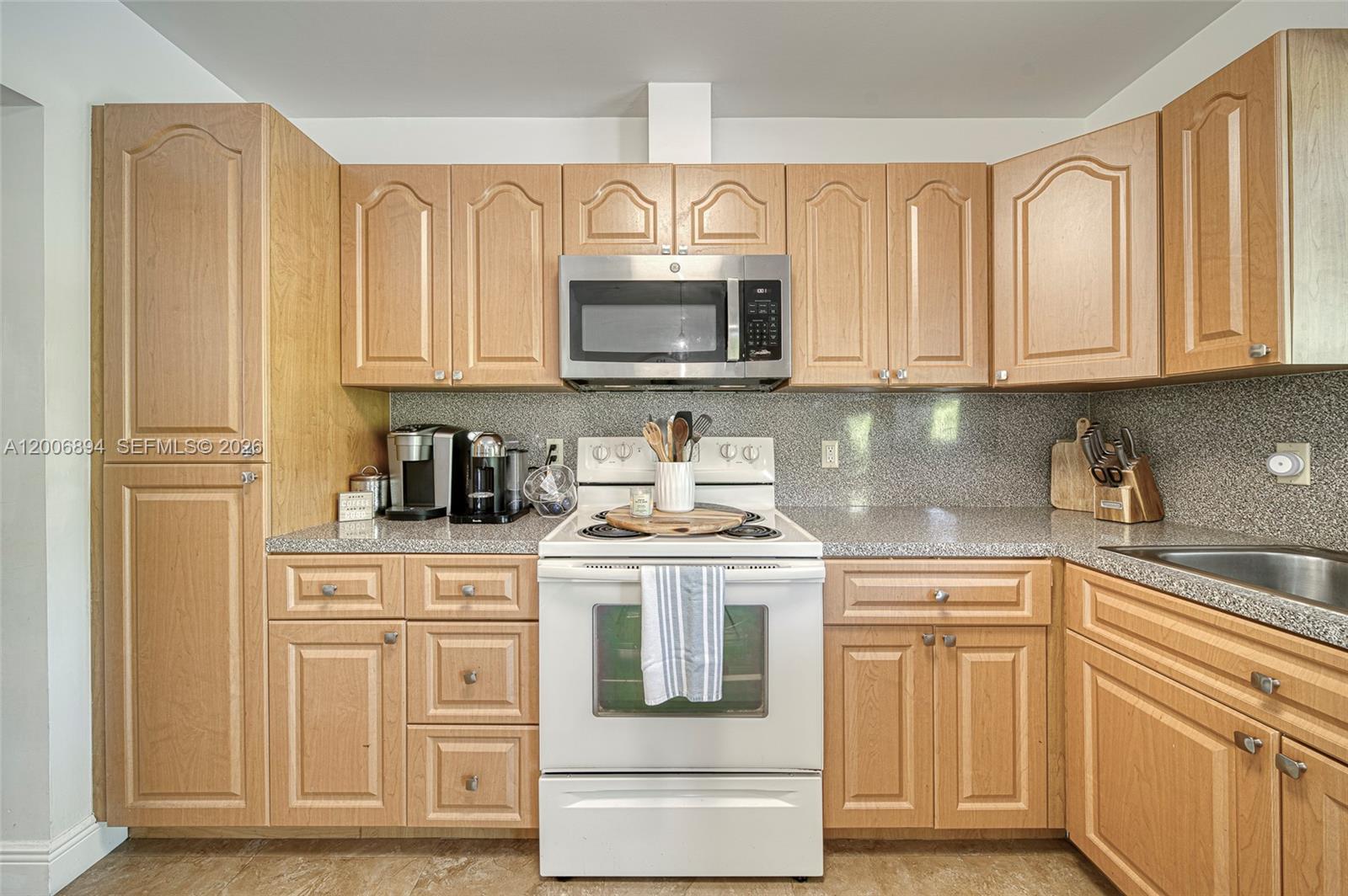 10600 Southwest 80th Court Miami, FL 33156 - Photo 11 of 51 a kitchen with stainless steel appliances granite countertop a stove a sink and a refrigerator