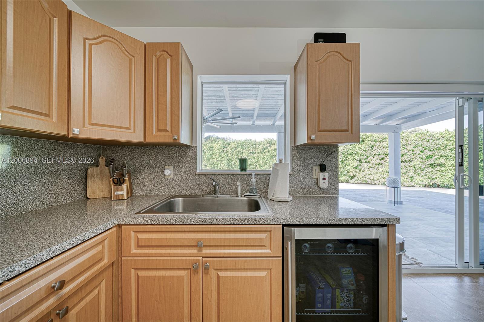 10600 Southwest 80th Court Miami, FL 33156 - Photo 12 of 51 a kitchen with granite countertop a sink cabinets and window