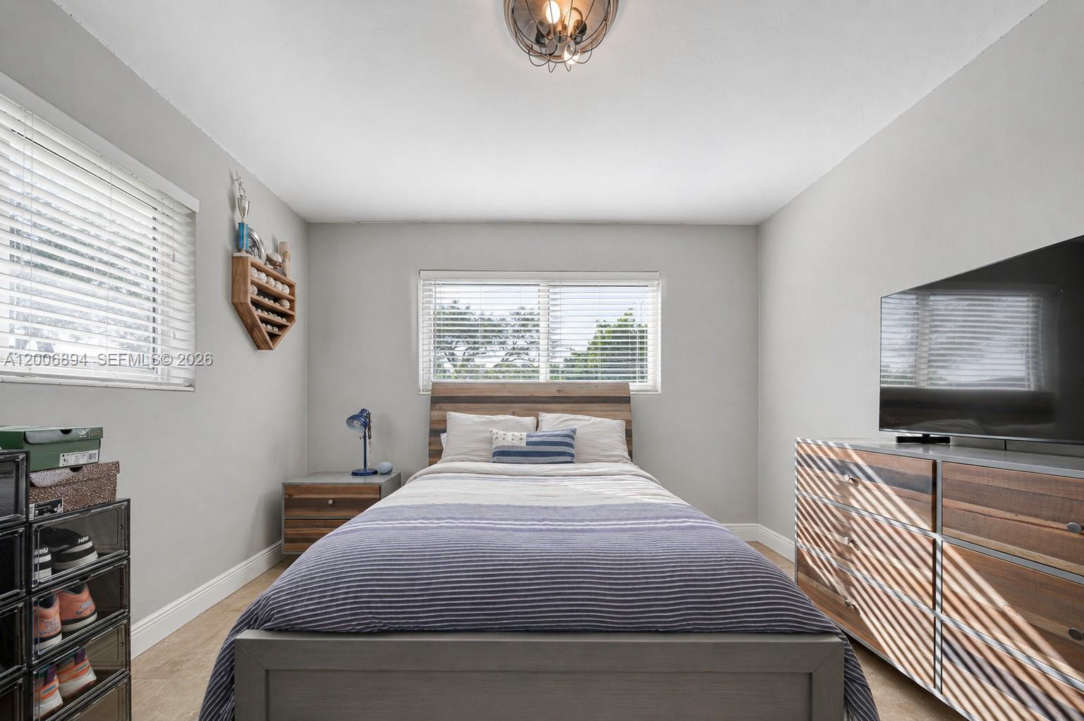 10600 Southwest 80th Court Miami, FL 33156 - Photo 14 of 51 a bedroom with a bed and window