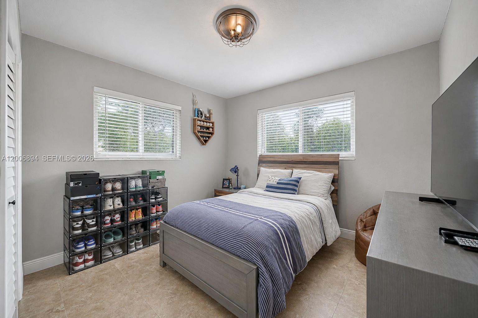 10600 Southwest 80th Court Miami, FL 33156 - Photo 16 of 51 a bedroom with a bed and a window