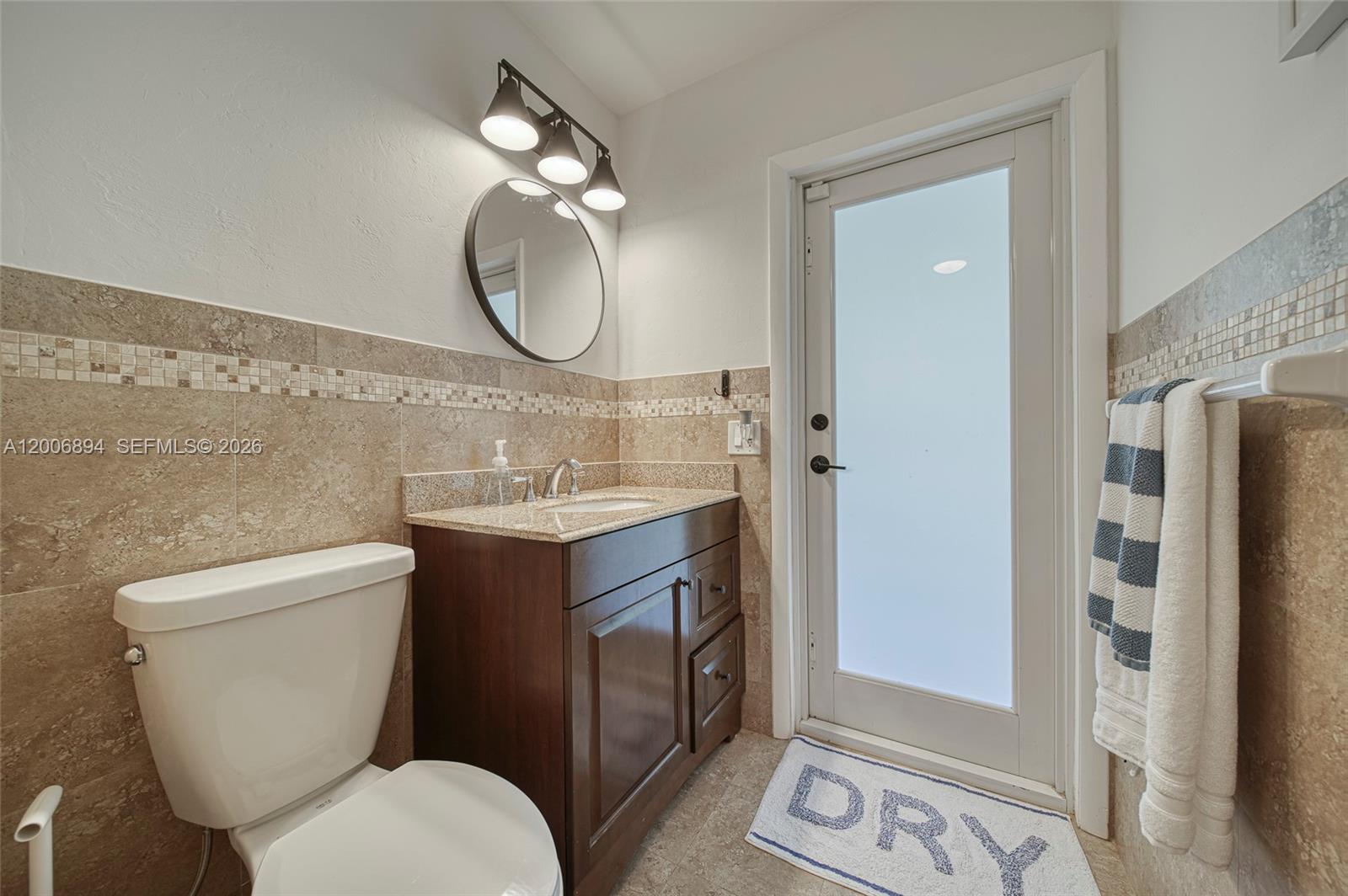 10600 Southwest 80th Court Miami, FL 33156 - Photo 18 of 51 a bathroom with a toilet a sink and a mirror
