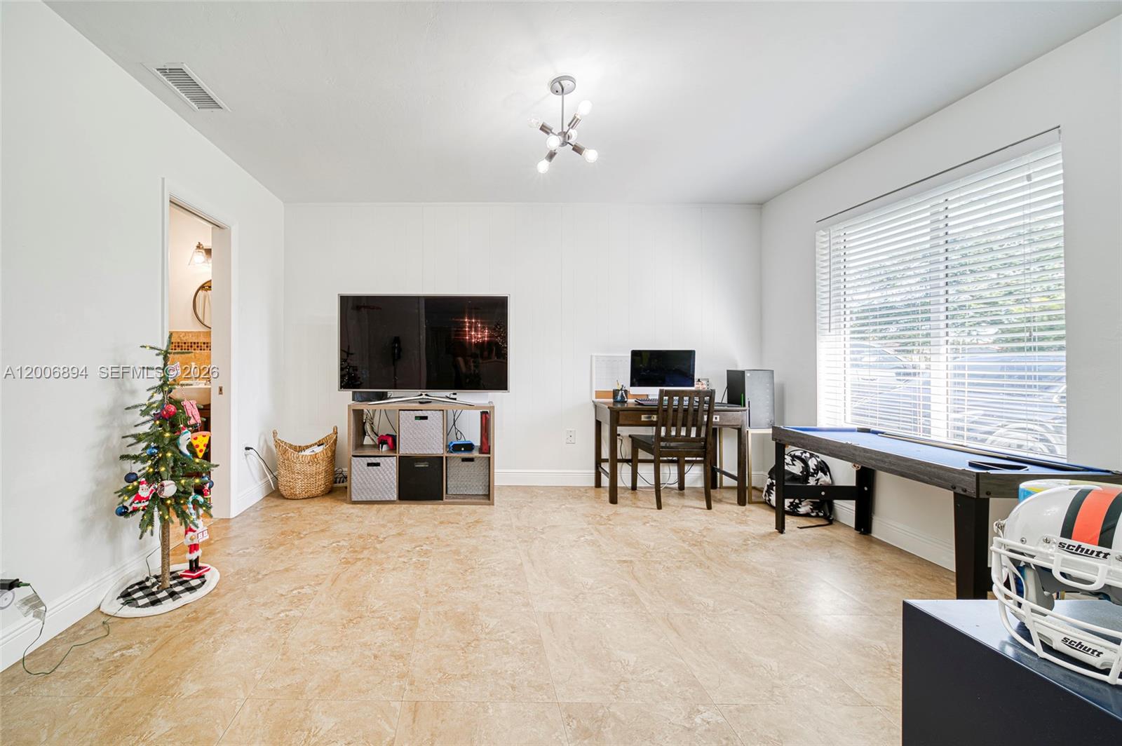 10600 Southwest 80th Court Miami, FL 33156 - Photo 20 of 51 a view of a livingroom with furniture and a flat screen tv