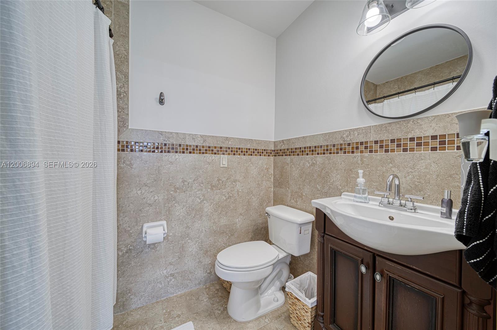 10600 Southwest 80th Court Miami, FL 33156 - Photo 21 of 51 a bathroom with a sink mirror vanity and toilet