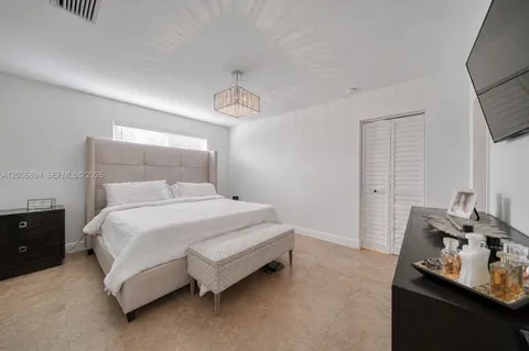 a bedroom with a bed and window