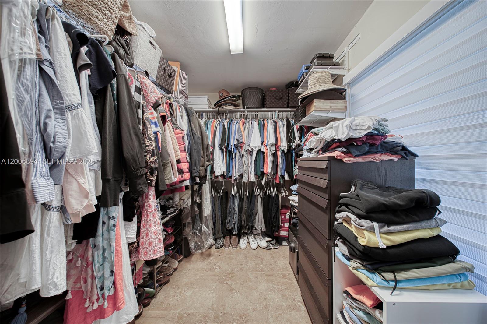 10600 Southwest 80th Court Miami, FL 33156 - Photo 27 of 51 a view of walk in closet with clothes and shoes
