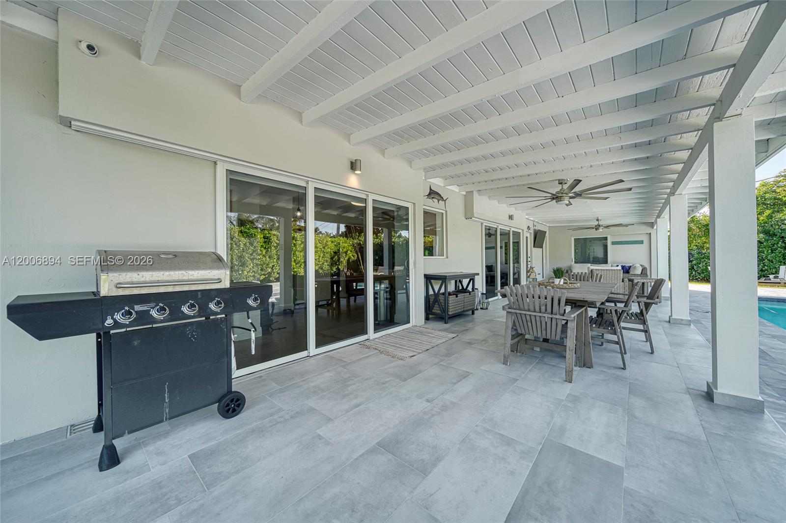 10600 Southwest 80th Court Miami, FL 33156 - Photo 29 of 51 a dining room with furniture and a fireplace