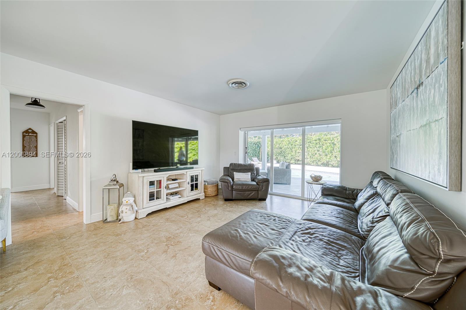 10600 Southwest 80th Court Miami, FL 33156 - Photo 3 of 51 a living room with furniture and a flat screen tv