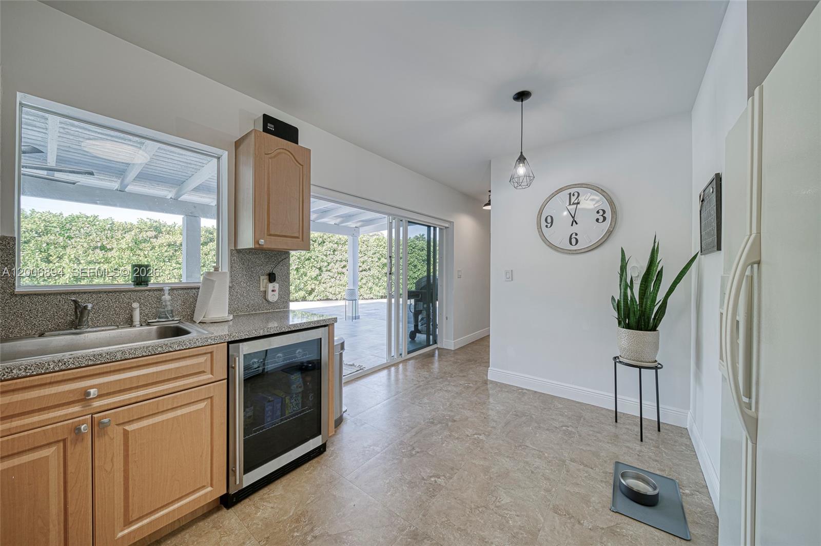 10600 Southwest 80th Court Miami, FL 33156 - Photo 9 of 51 a kitchen with a stove a sink cabinetry and a large window