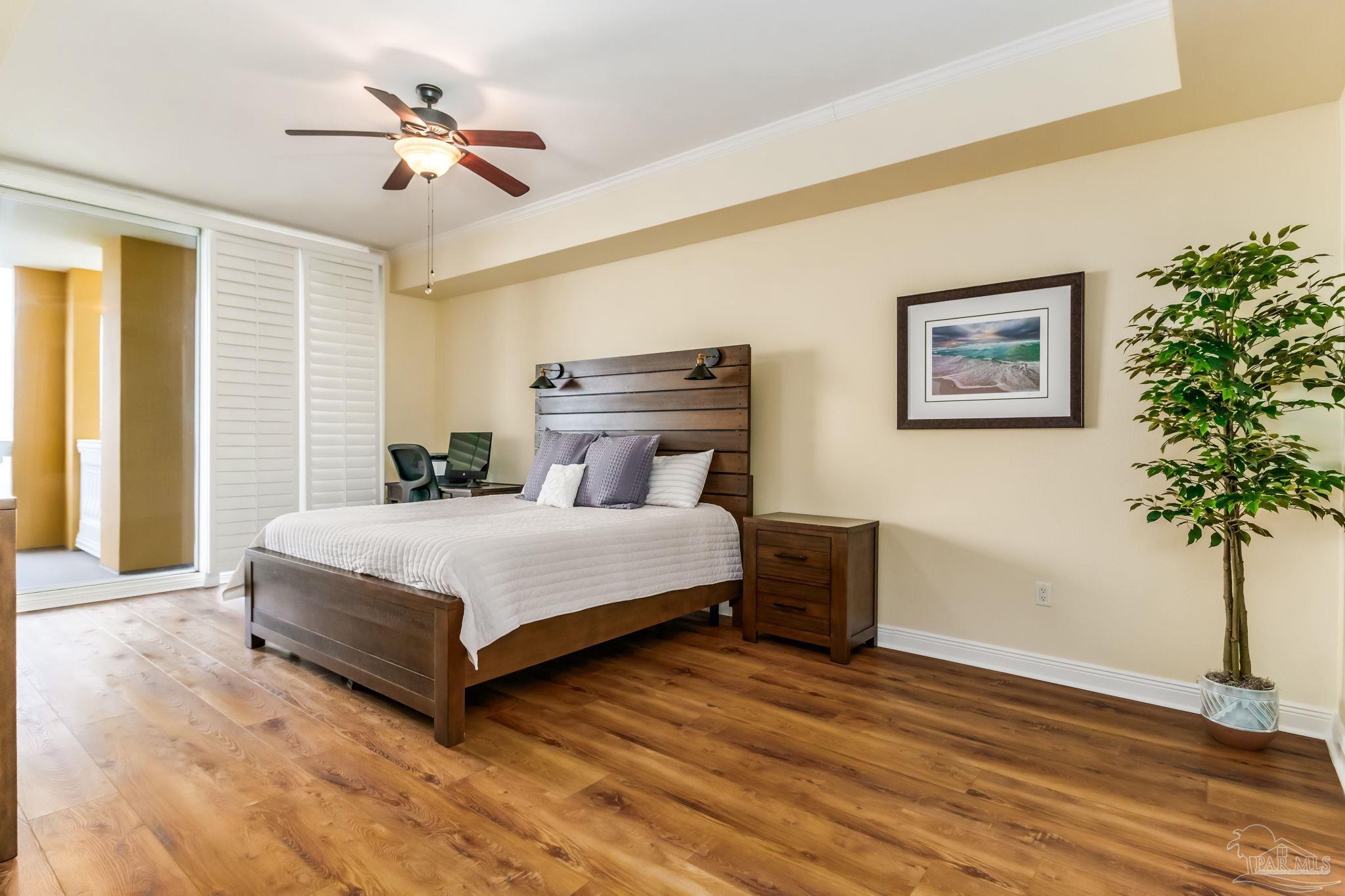 14500 River Road, Unit 406 Pensacola, FL 32507 - Photo 17 of 45 a bedroom with a large bed and a potted plant