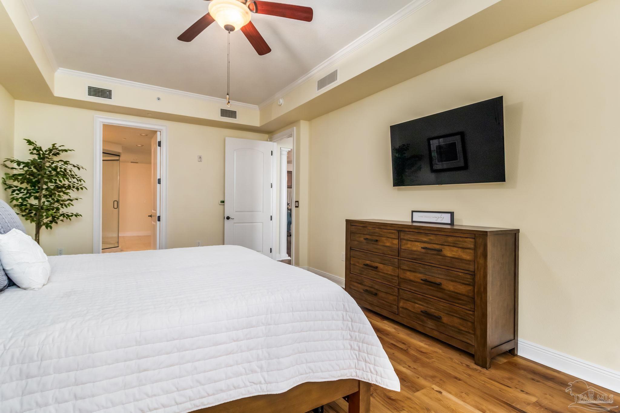 14500 River Road, Unit 406 Pensacola, FL 32507 - Photo 18 of 45 a bedroom with a bed and a flat tv screen