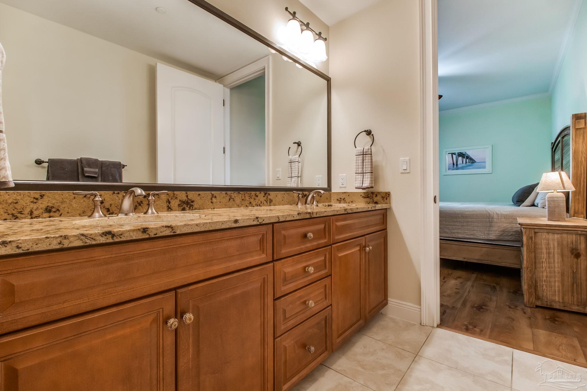 14500 River Road, Unit 406 Pensacola, FL 32507 - Photo 22 of 45 a spacious bathroom with a granite countertop sink and a mirror
