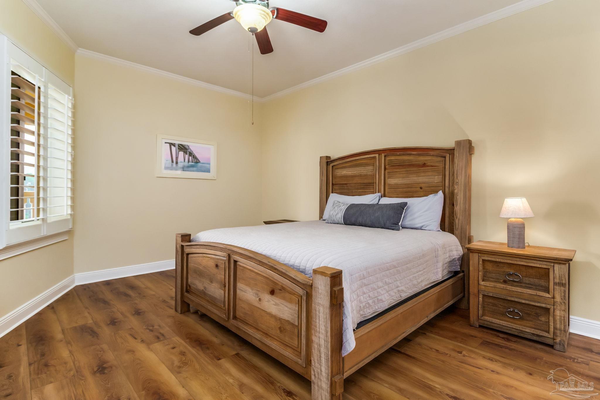 14500 River Road, Unit 406 Pensacola, FL 32507 - Photo 23 of 45 a bedroom with a bed and a chandelier