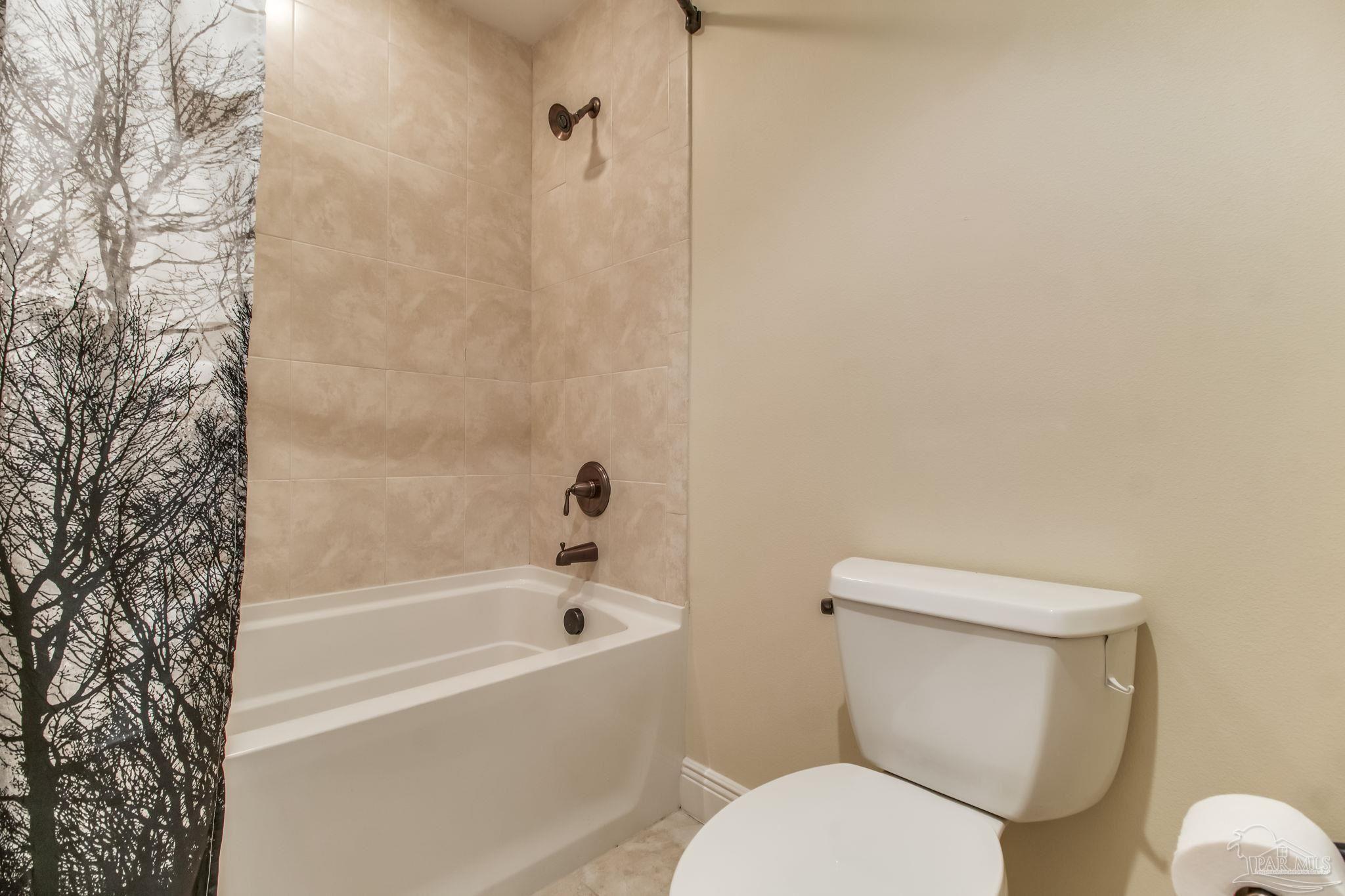 14500 River Road, Unit 406 Pensacola, FL 32507 - Photo 25 of 45 a white toilet sitting next to a bath tub
