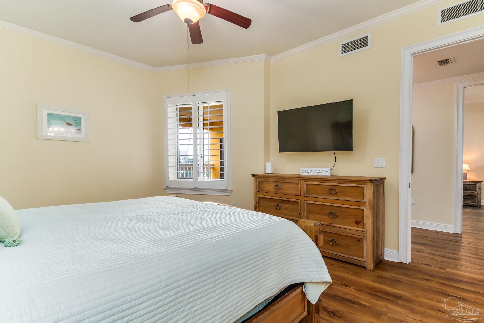 14500 River Road, Unit 406 Pensacola, FL 32507 - Photo 26 of 45 a bedroom with a bed and a flat screen tv