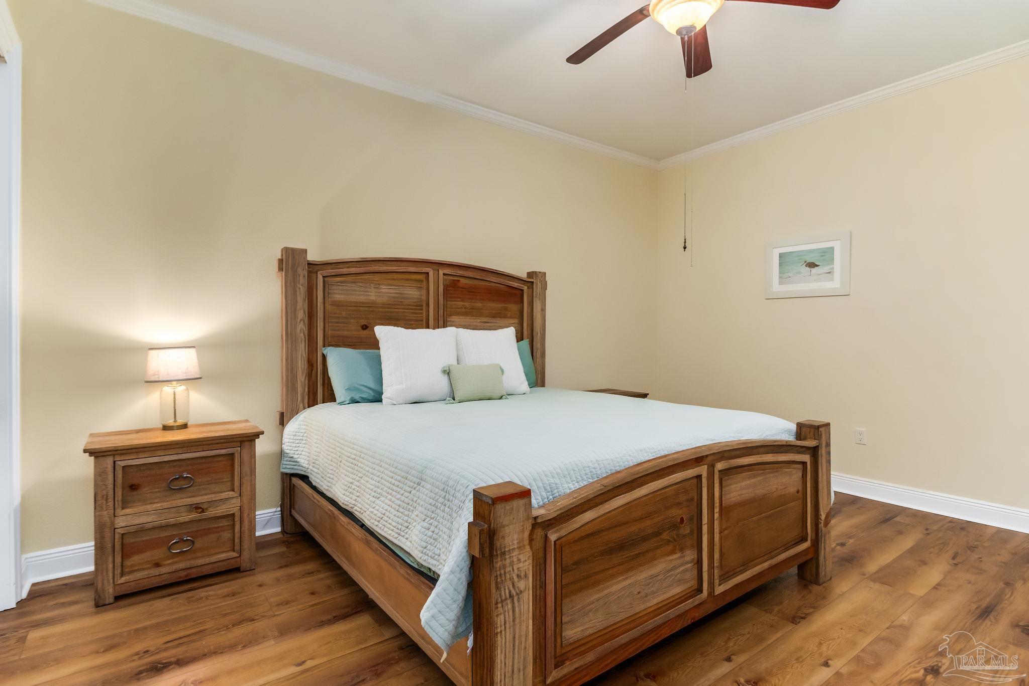 14500 River Road, Unit 406 Pensacola, FL 32507 - Photo 27 of 45 a bed room with a bed and a ceiling fan