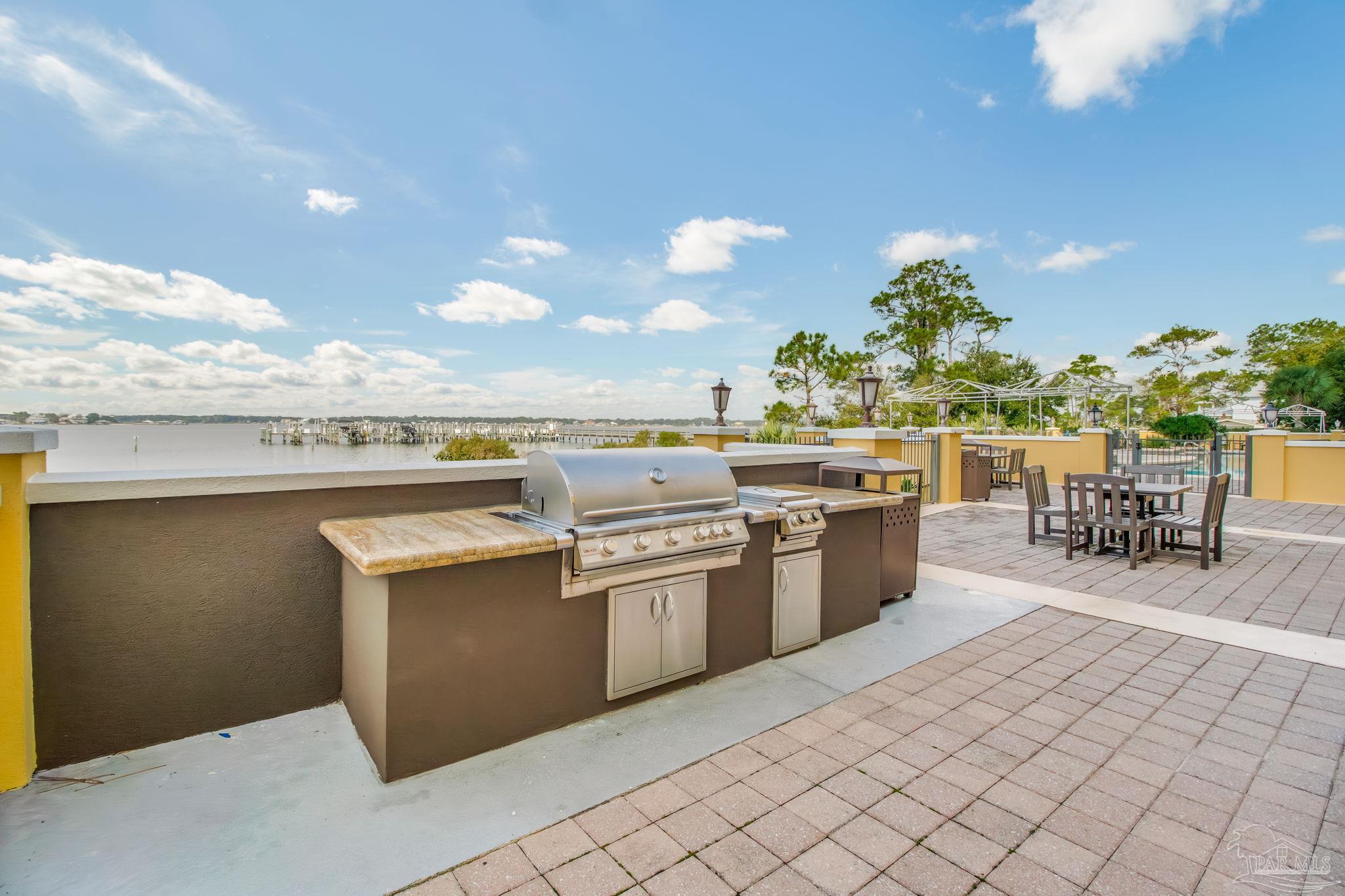 14500 River Road, Unit 406 Pensacola, FL 32507 - Photo 40 of 45 a kitchen with a sink and chairs
