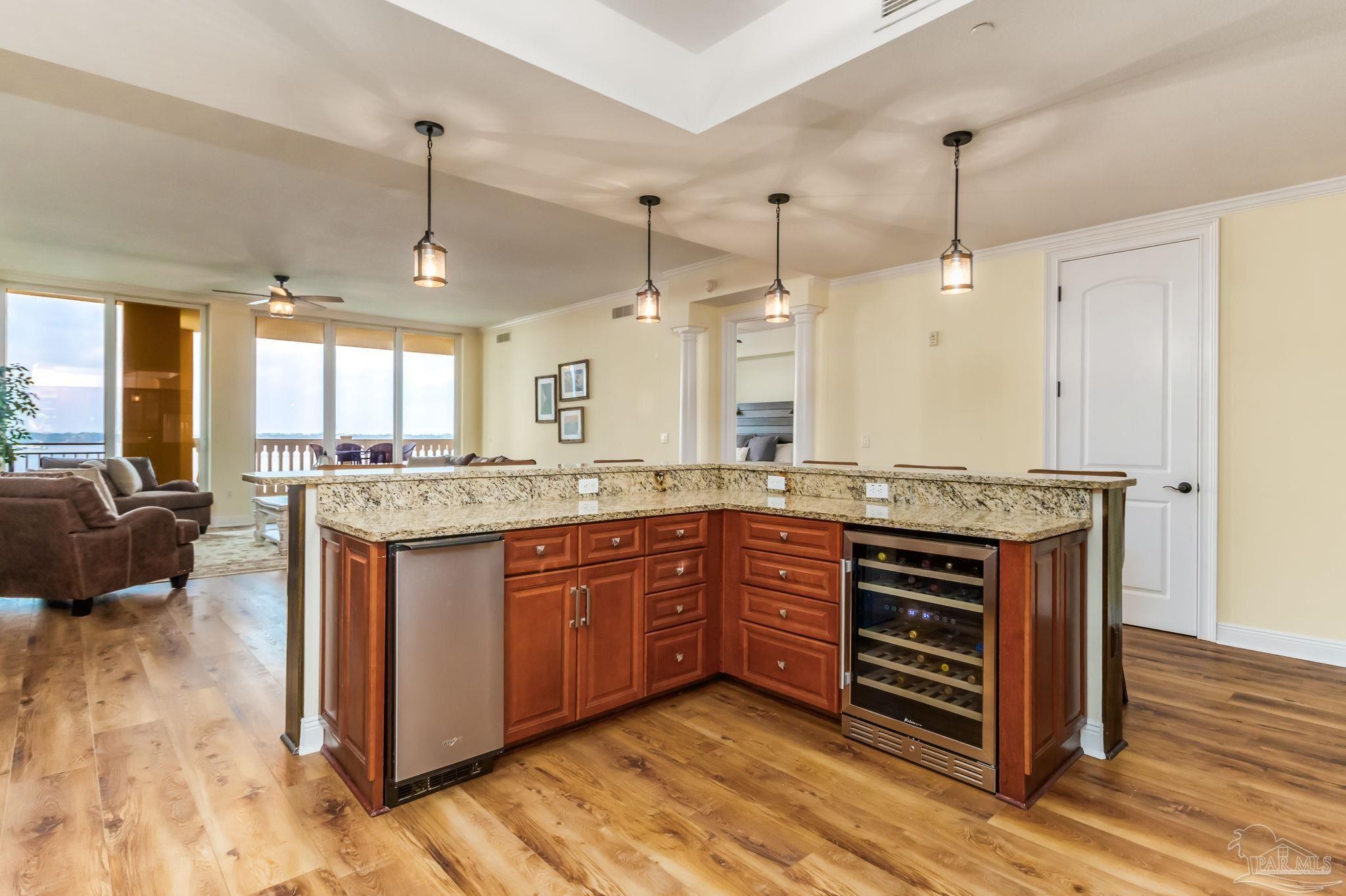 14500 River Road, Unit 406 Pensacola, FL 32507 - Photo 4 of 45 a large kitchen with granite countertop a stove and a sink