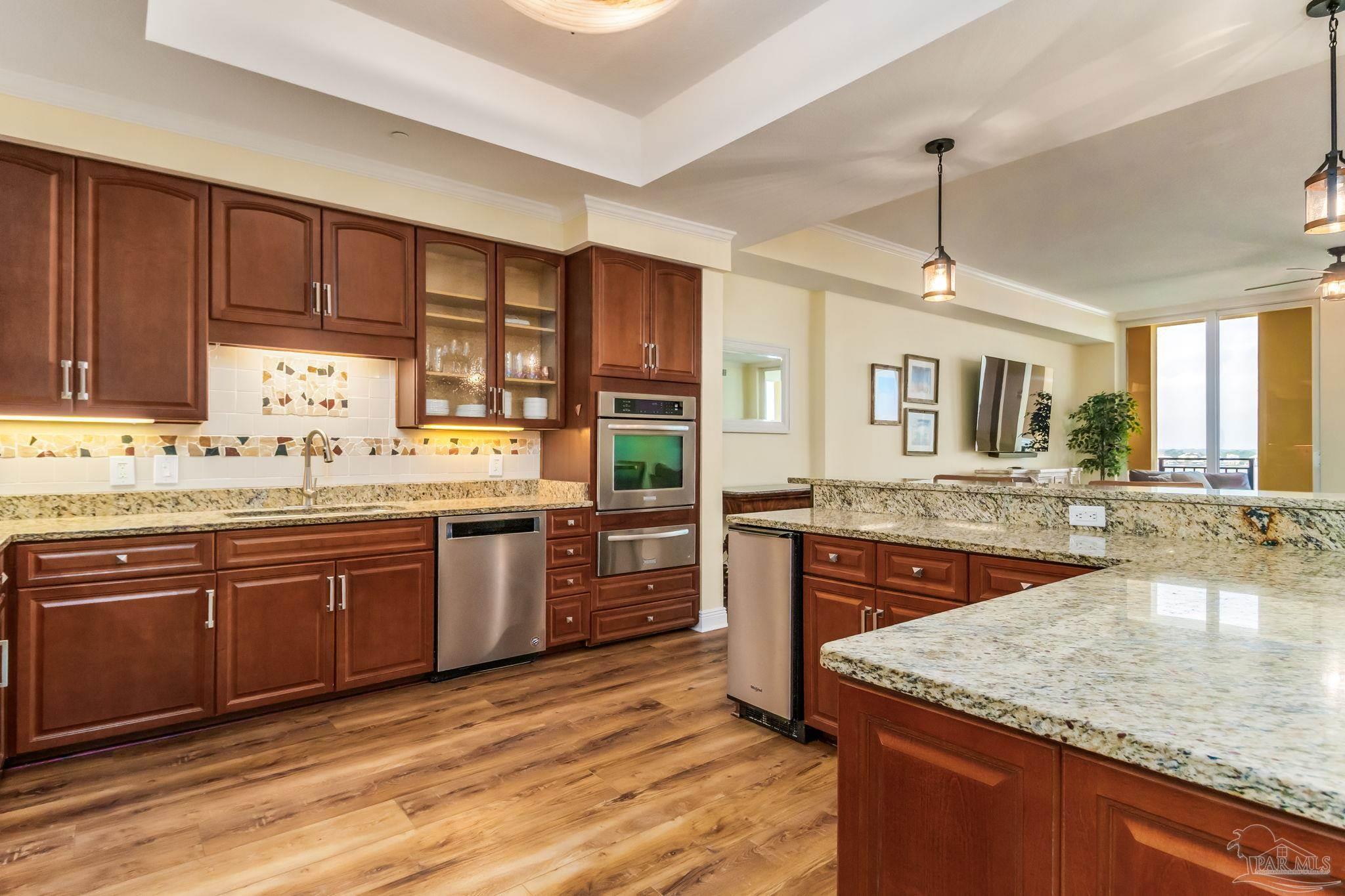 14500 River Road, Unit 406 Pensacola, FL 32507 - Photo 7 of 45 a large kitchen with granite countertop a sink counter space appliances and cabinets