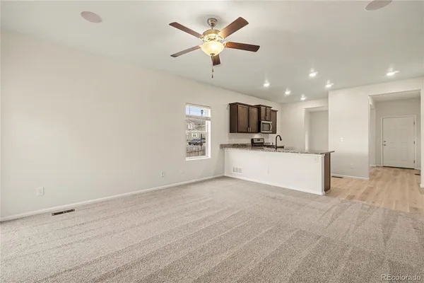a view of kitchen with microwave and a sink