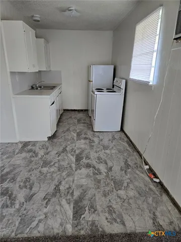 a utility room with cabinets washer and dryer