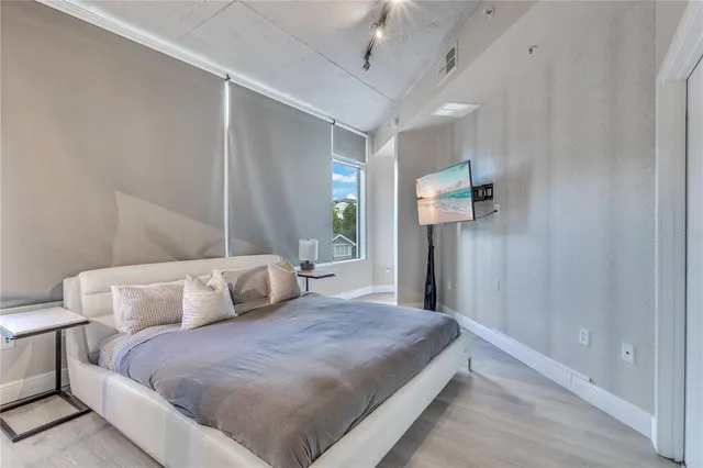 a spacious bathroom with a toilet a sink and mirror