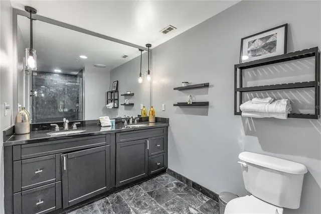 a bathroom with a toilet sink and shower