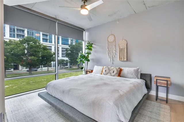 a bed sitting in a bedroom next to a window