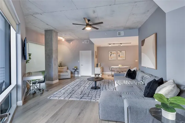 a living room with furniture and wooden floor