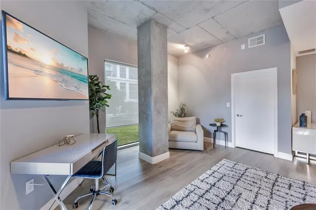 a kitchen with stainless steel appliances kitchen island granite countertop a sink and a refrigerator