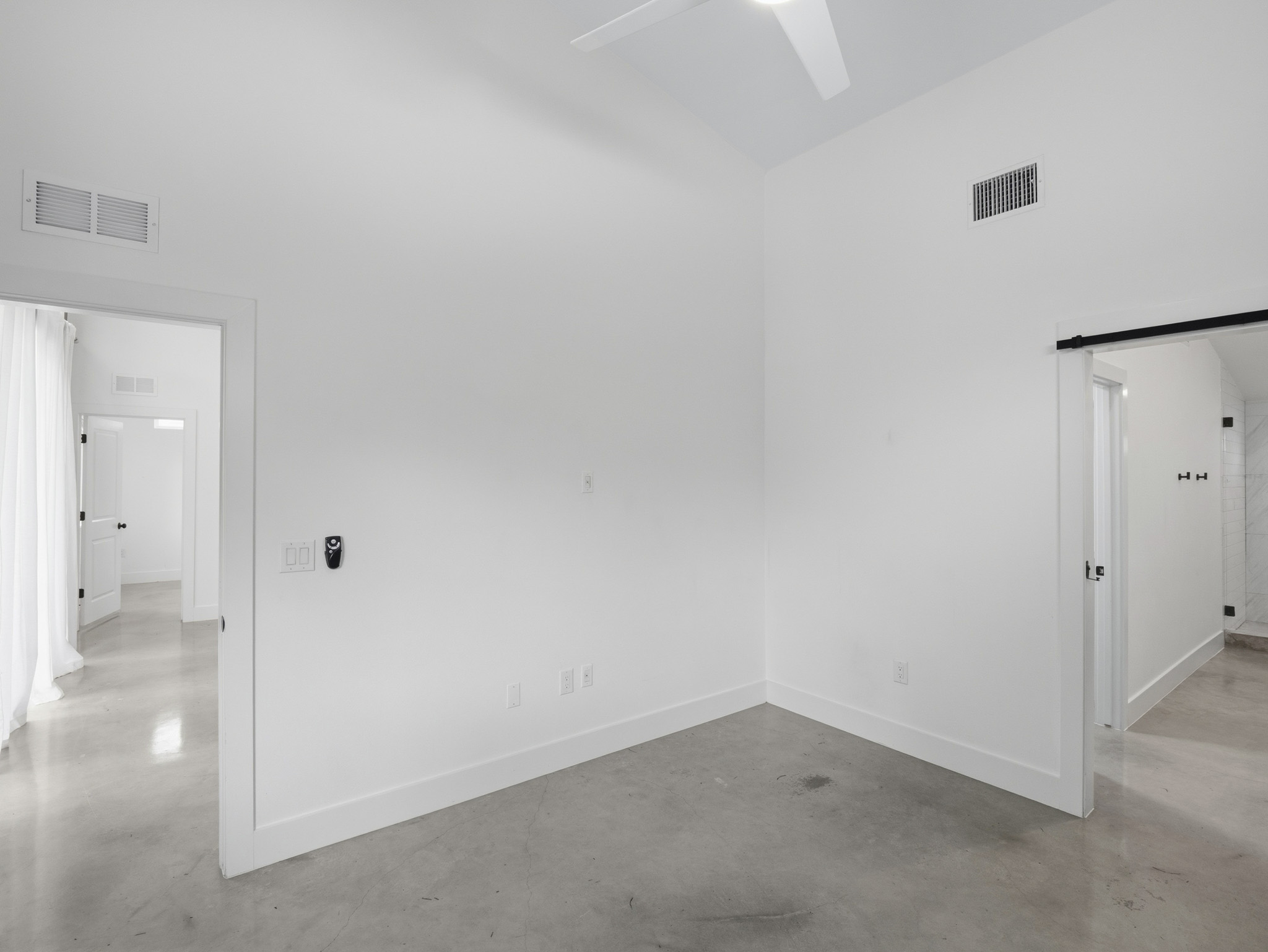 5005 Lott Avenue, Unit 2 Austin, TX 78721 - Photo 24 of 25 Minimalist design defines this bedroom, offering a serene and uncluttered personal sanctuary.