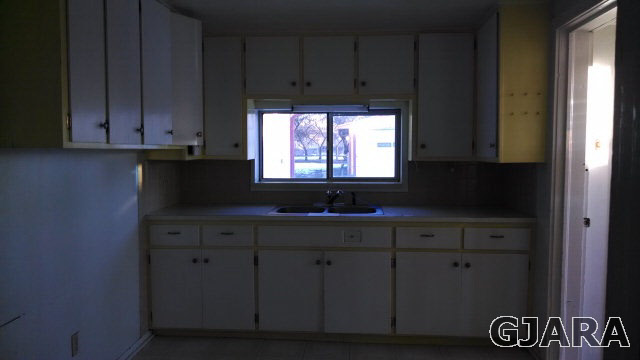 2908 Patterson Road Grand Junction, CO 81504 - Photo 4 of 6 a kitchen with granite countertop cabinets and window