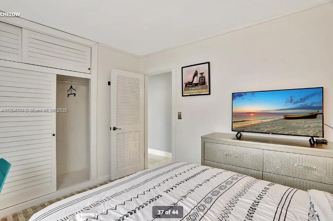 2321 Southeast 15th Street, Unit 2321 Pompano Beach, FL 33062 - Photo 14 of 26 a bedroom with a bed and a flat screen tv