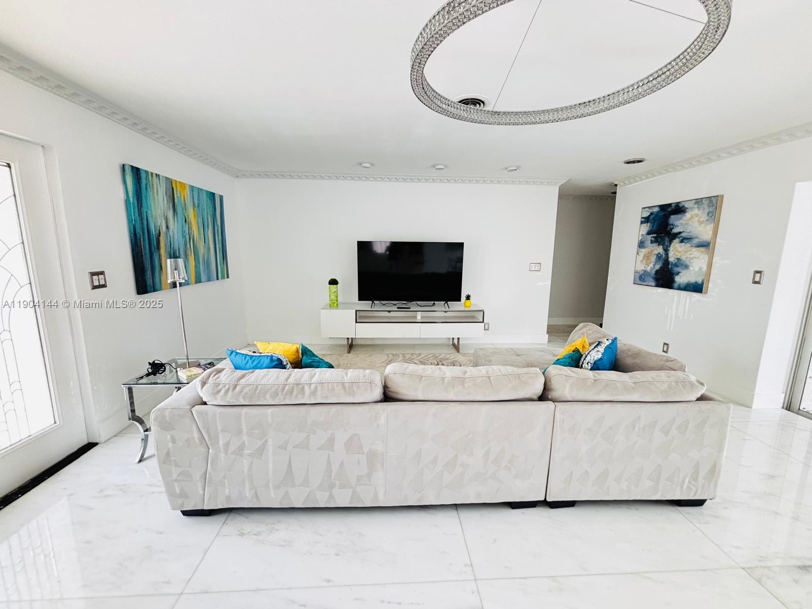 2321 Southeast 15th Street, Unit 2321 Pompano Beach, FL 33062 - Photo 21 of 26 a living room with a couch and a flat screen tv