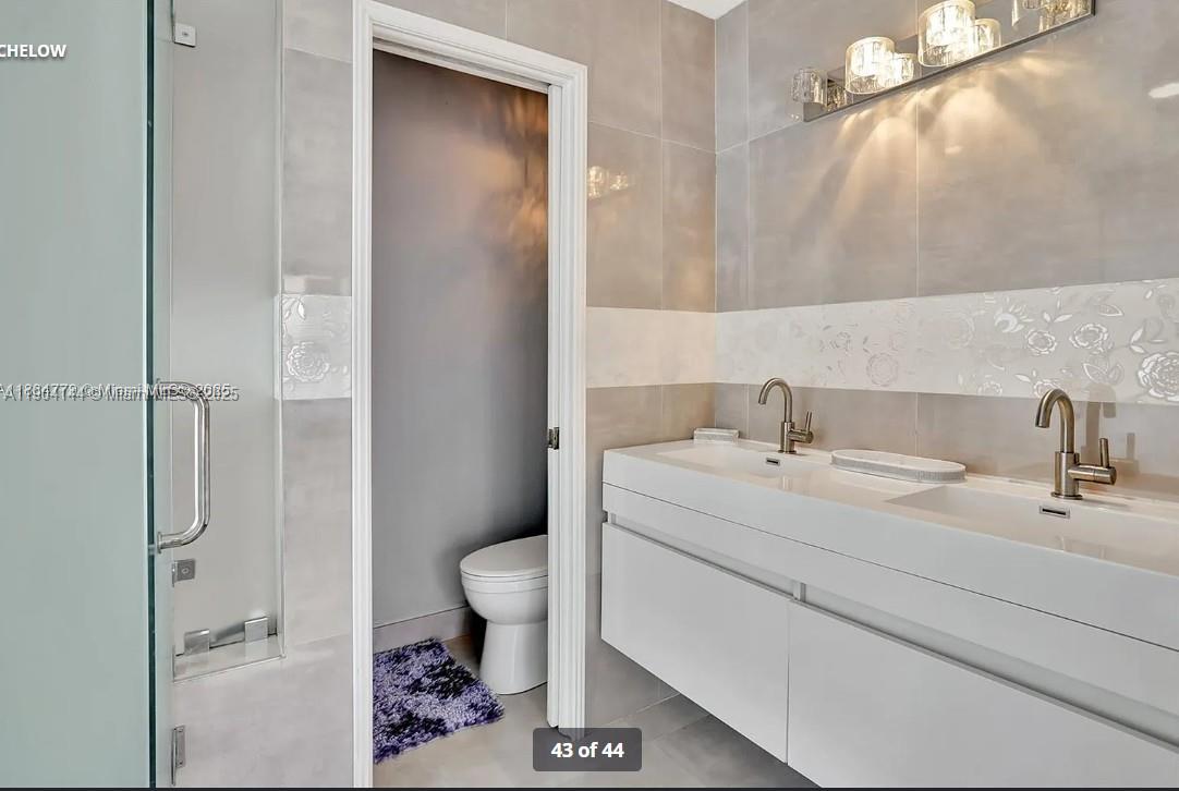 2321 Southeast 15th Street, Unit 2321 Pompano Beach, FL 33062 - Photo 24 of 26 a bathroom with a sink toilet and shower