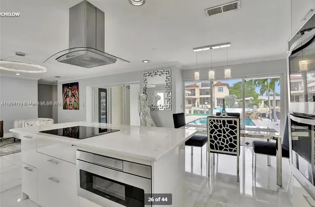 a kitchen with stainless steel appliances kitchen island a table and chairs