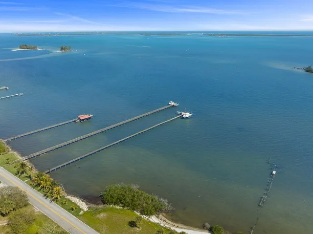 an aerial view of residential houses with outdoor space and river
