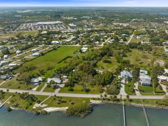 an aerial view of a houses with a yard