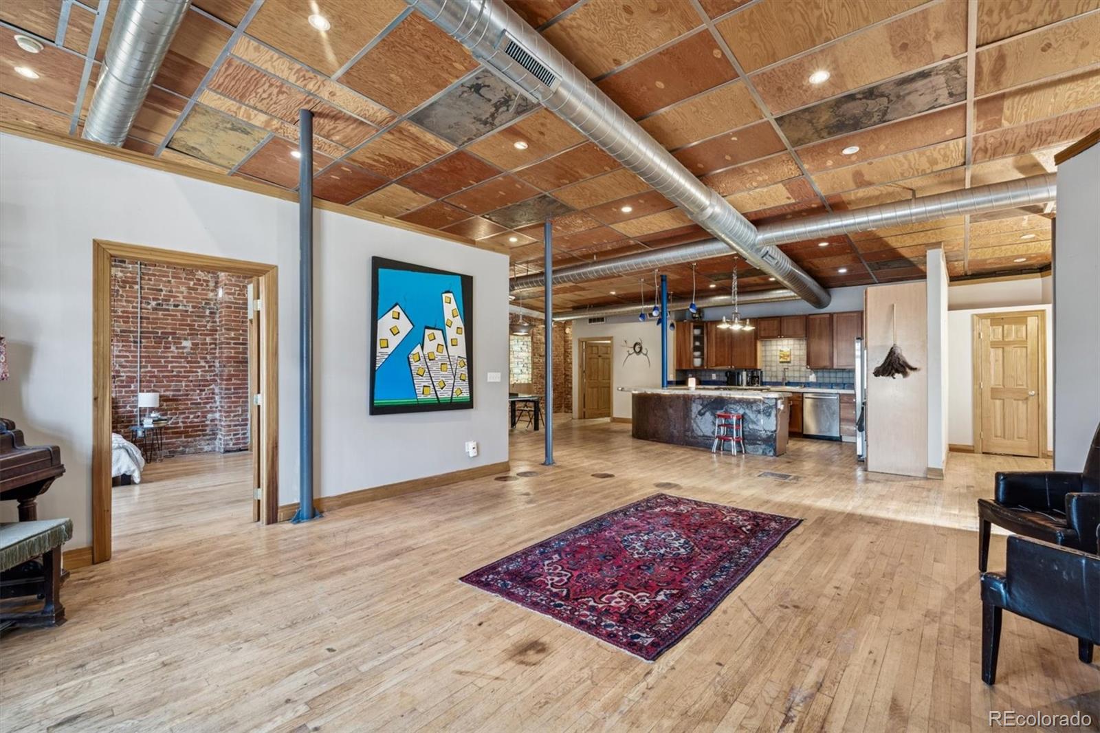 760 Santa Fe Drive, Unit 2 Denver, CO 80204 - Photo 1 of 33 a living room with lots of furniture and a rug