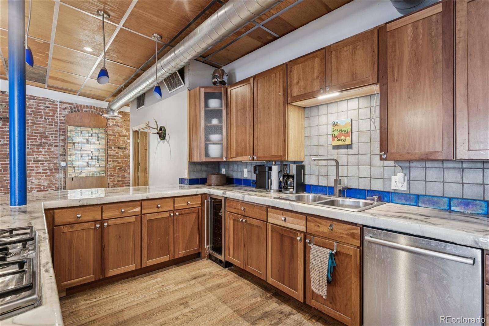 760 Santa Fe Drive, Unit 2 Denver, CO 80204 - Photo 12 of 33 a kitchen with a sink stove and cabinets