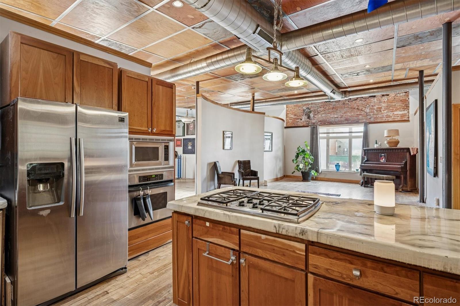 760 Santa Fe Drive, Unit 2 Denver, CO 80204 - Photo 14 of 33 a kitchen with stainless steel appliances granite countertop a sink a stove and refrigerator