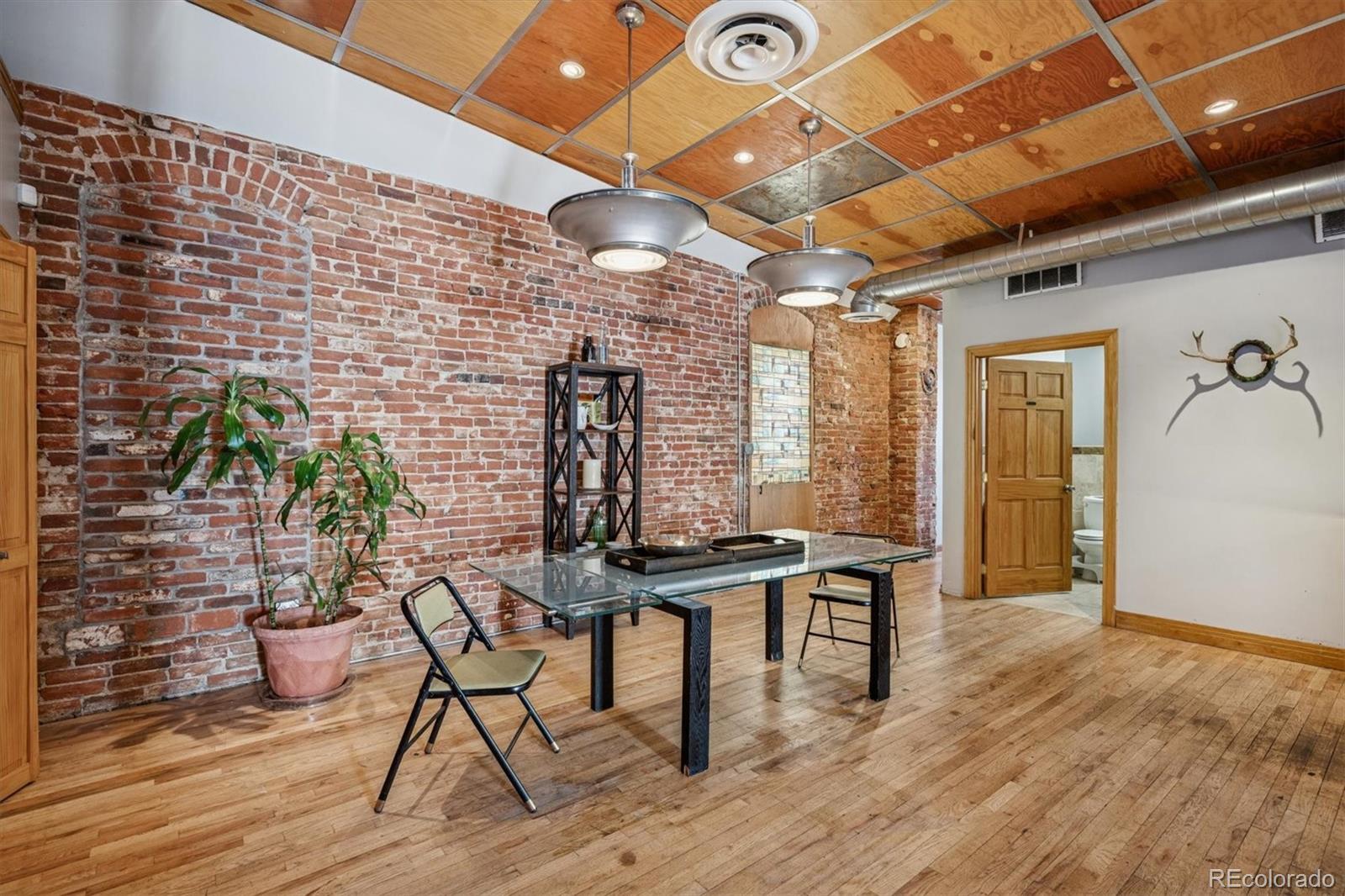 760 Santa Fe Drive, Unit 2 Denver, CO 80204 - Photo 15 of 33 a view of a room with table and chairs