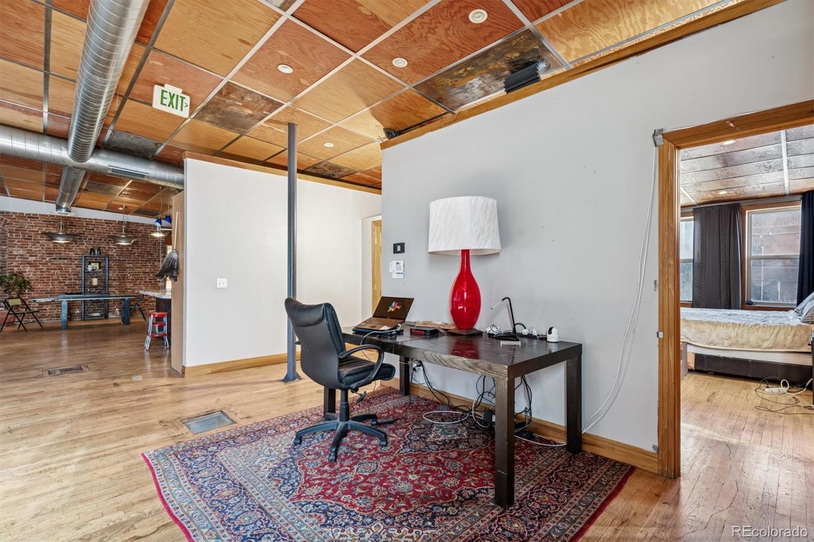 760 Santa Fe Drive, Unit 2 Denver, CO 80204 - Photo 17 of 33 a work room with furniture and wooden floor