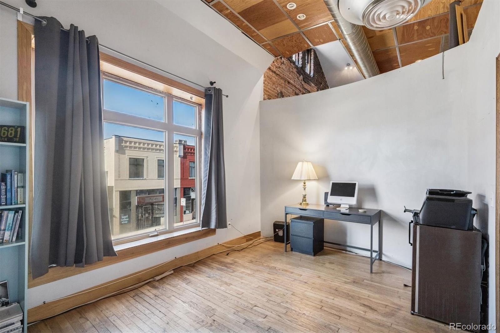 760 Santa Fe Drive, Unit 2 Denver, CO 80204 - Photo 20 of 33 a view of a workspace with furniture and a window