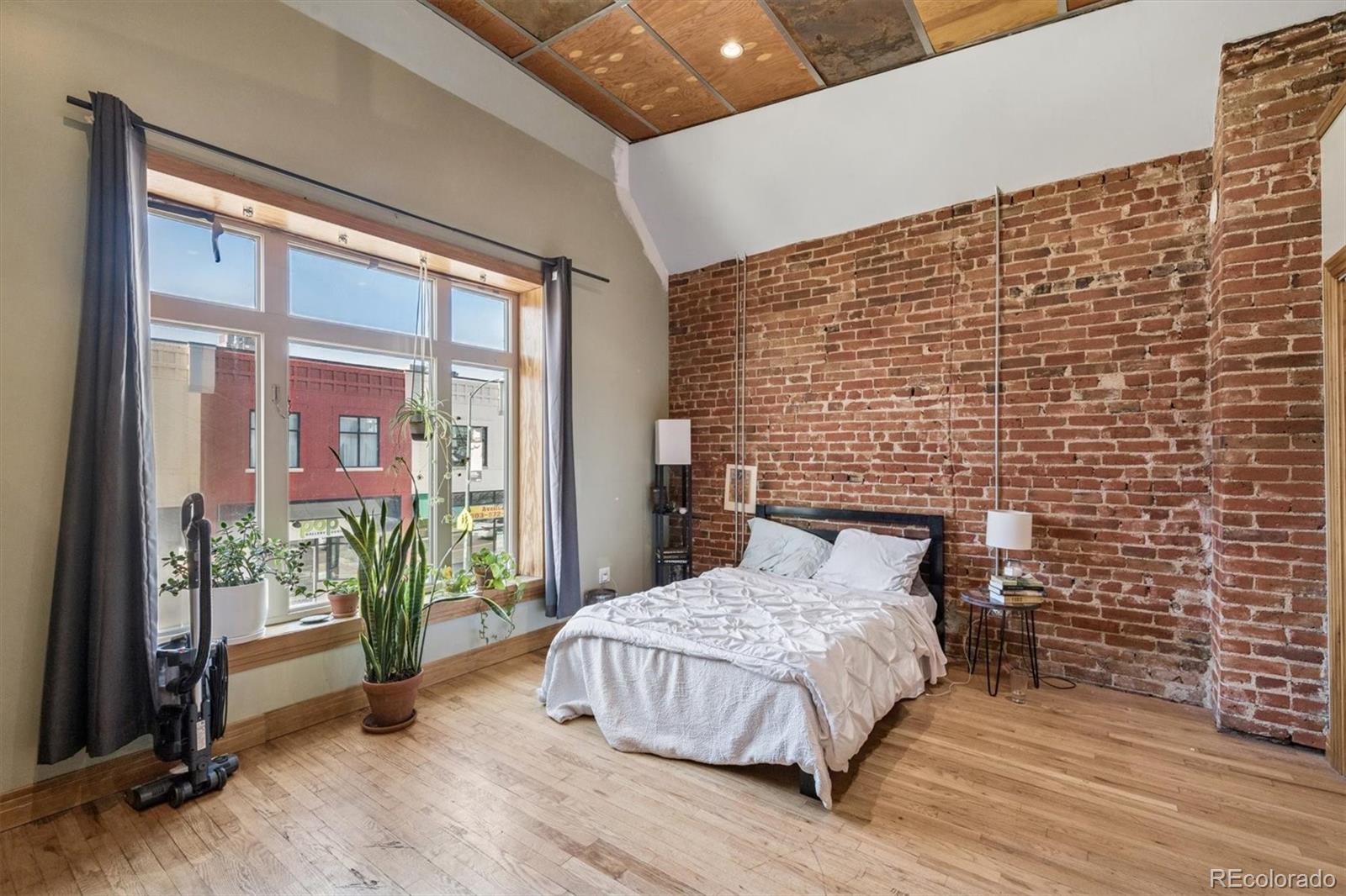 760 Santa Fe Drive, Unit 2 Denver, CO 80204 - Photo 22 of 33 a bedroom with a bed and a window