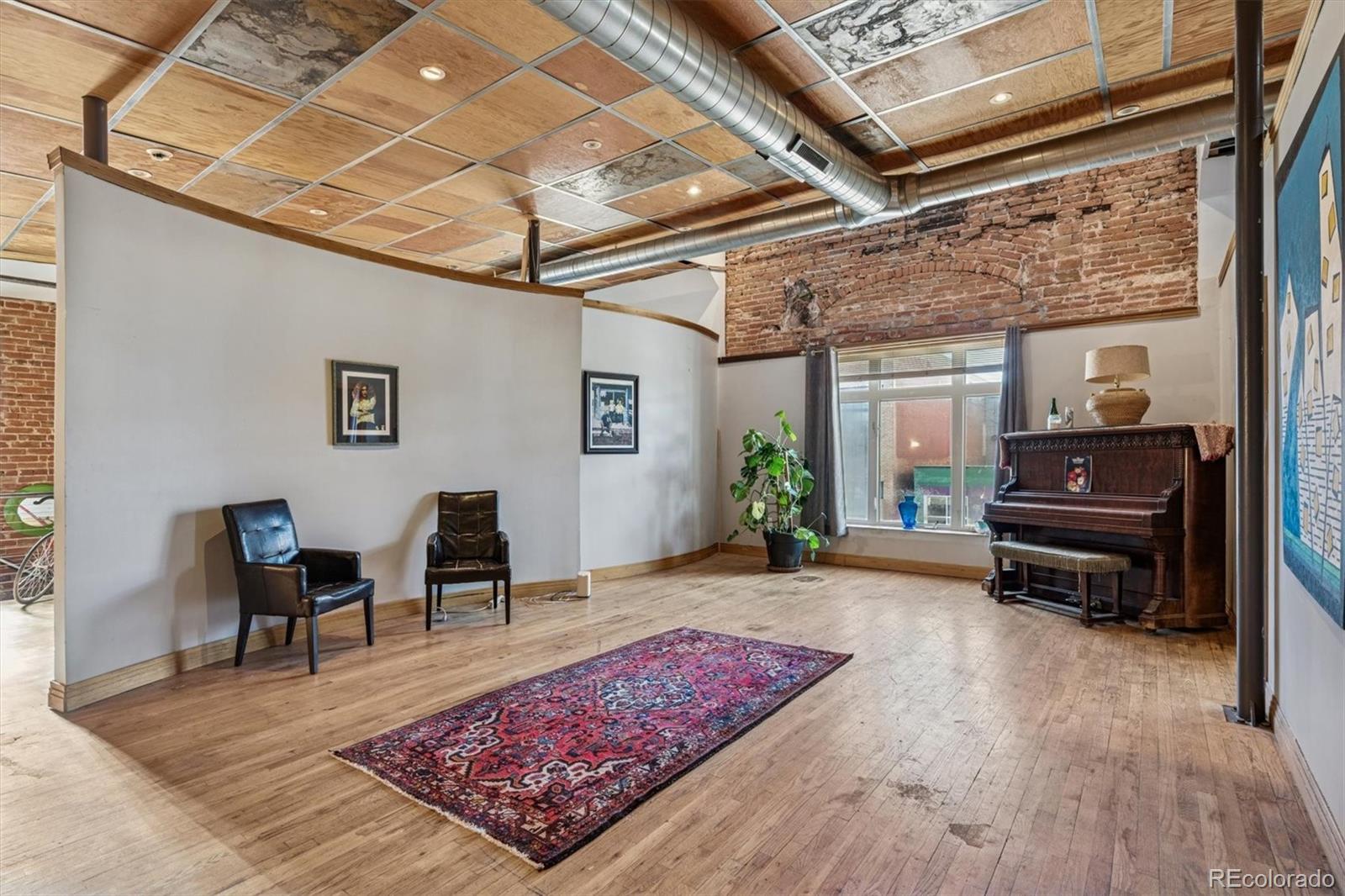 760 Santa Fe Drive, Unit 2 Denver, CO 80204 - Photo 6 of 33 a living room with furniture and a wooden floor