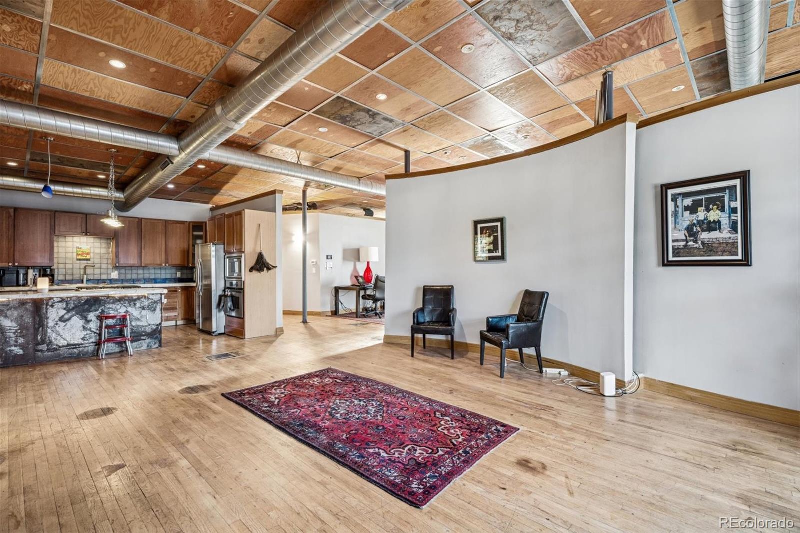 760 Santa Fe Drive, Unit 2 Denver, CO 80204 - Photo 7 of 33 a living room with furniture and a wooden floor
