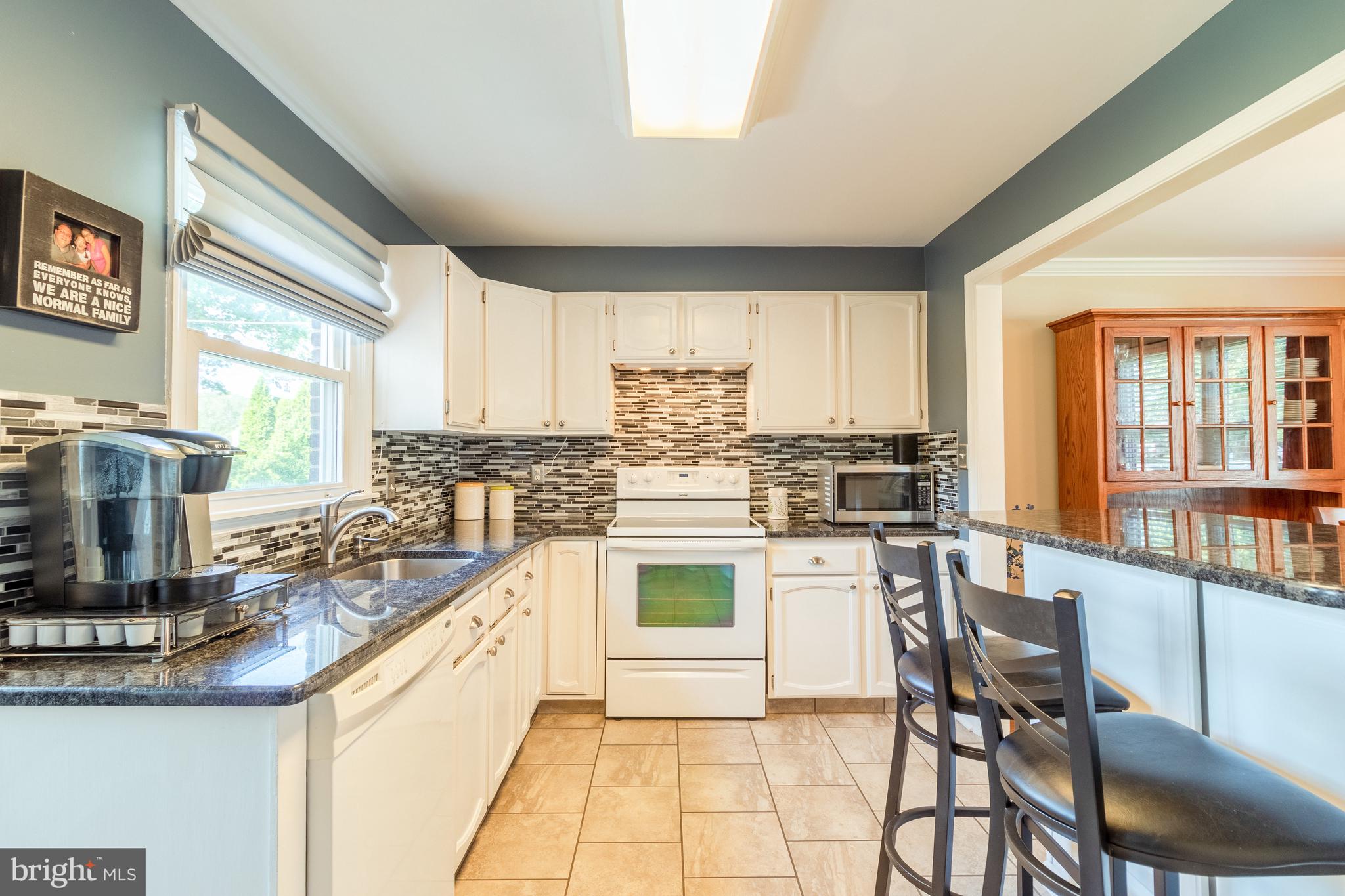 202 Sandra Road Wilmington, DE 19803 - Photo 9 of 25 Kitchen features new tile floor & breakfast bar